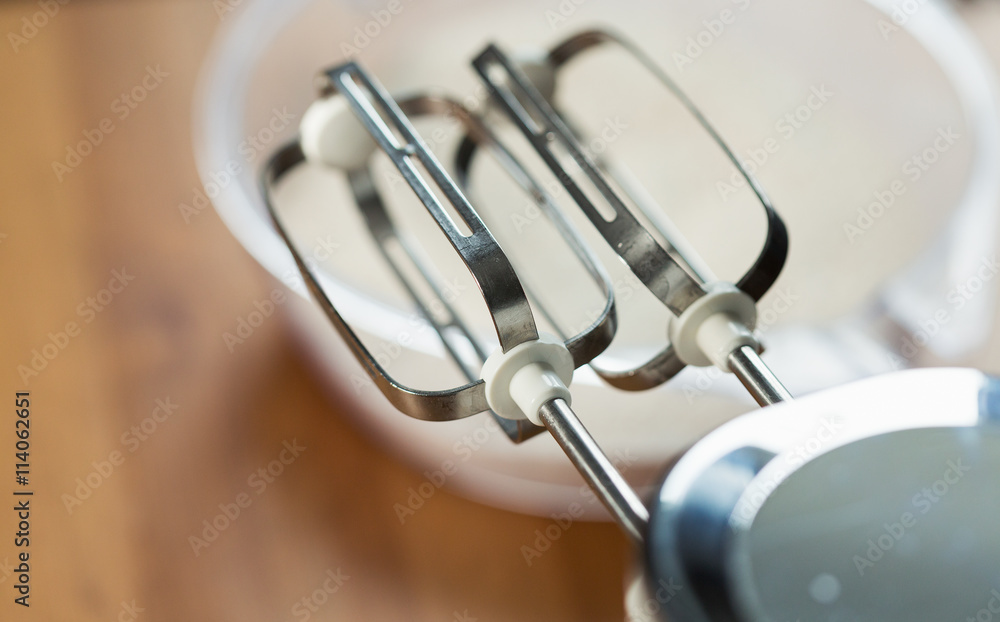 Whisking dough with mixer in a bowl Whisking dough with mixer in a bowl