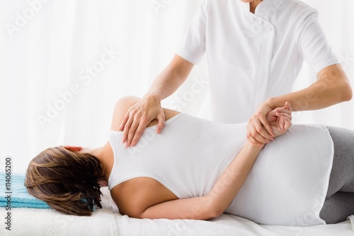 Obraz na plátně Masseur giving massage to woman