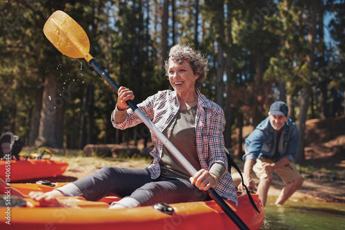 Mature couple enjoying a day at the lake with kayaking
