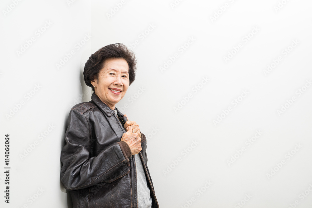old women wear leather jacket with text space old women wear leather jacket with text space