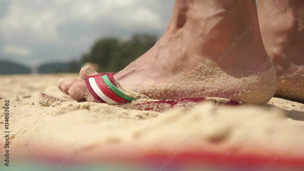 Man Putting Feet In Sandals On The Beach And Go To The Sea, Closeup, Big Closeup Man Putting Feet In Sandals On The Beach And Go To The Sea, Closeup, Big Closeup