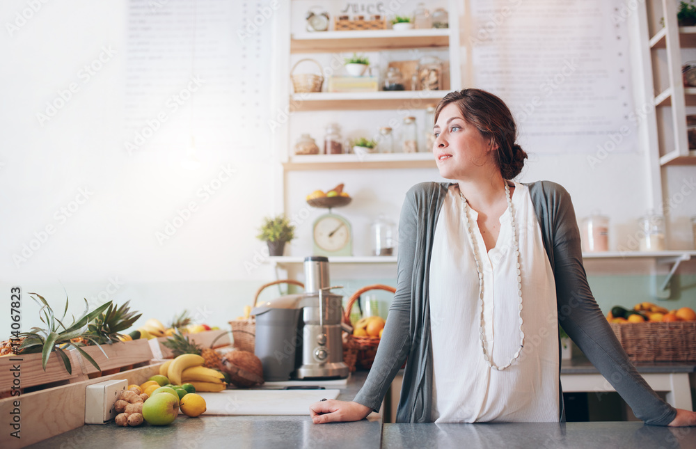Attractive young woman standing behind the counter Attractive young woman standing behind the counter