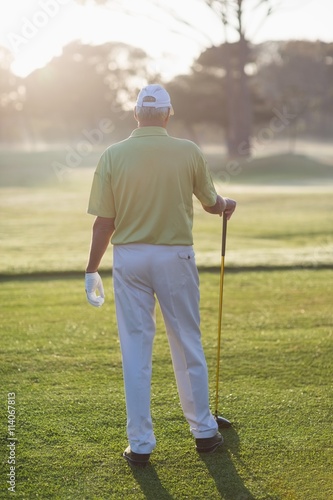 Rear view of man holding golf club 