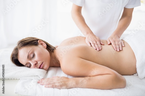 Masseur giving back massage to woman