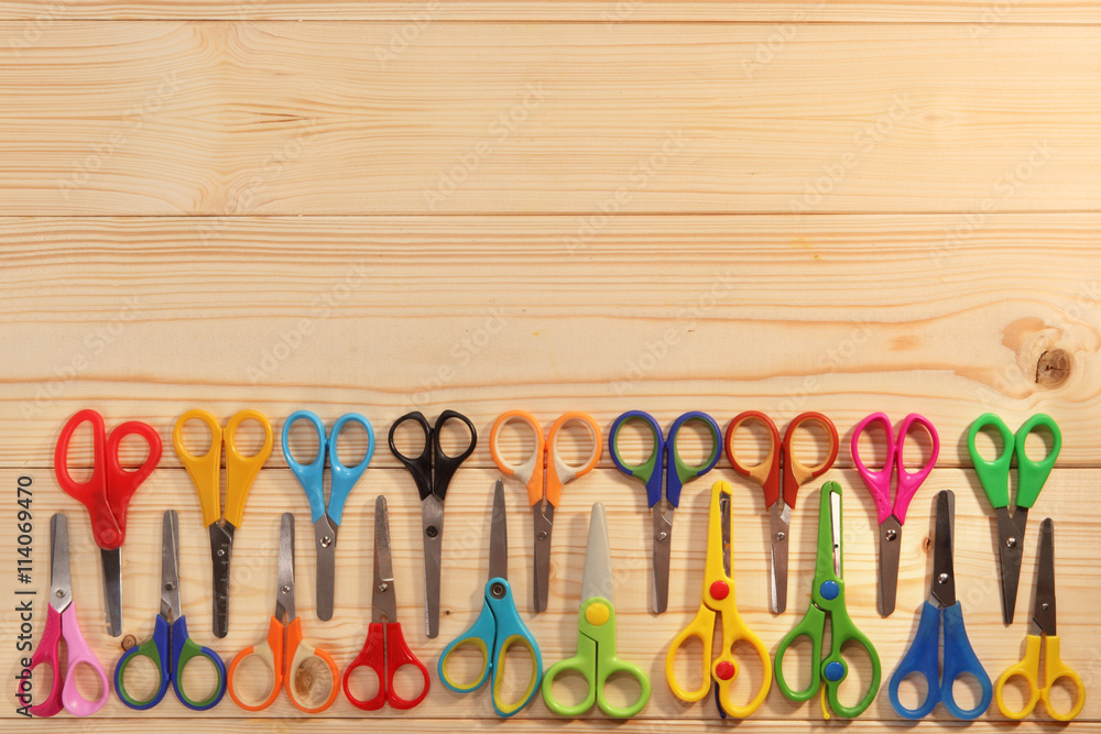 Bright scissors for kids on wooden background Bright scissors for kids on wooden background