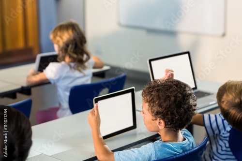 Children using digital tablets