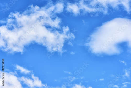 Puffy clouds on blue sky background