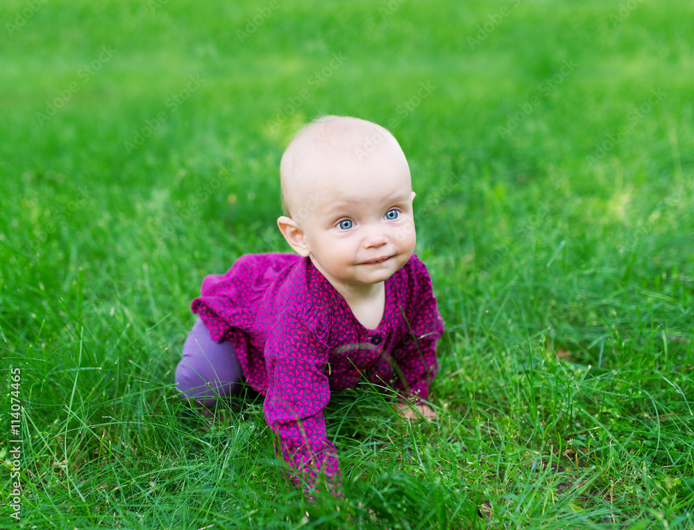 happy baby resting on the green grass. happy baby resting on the green grass.