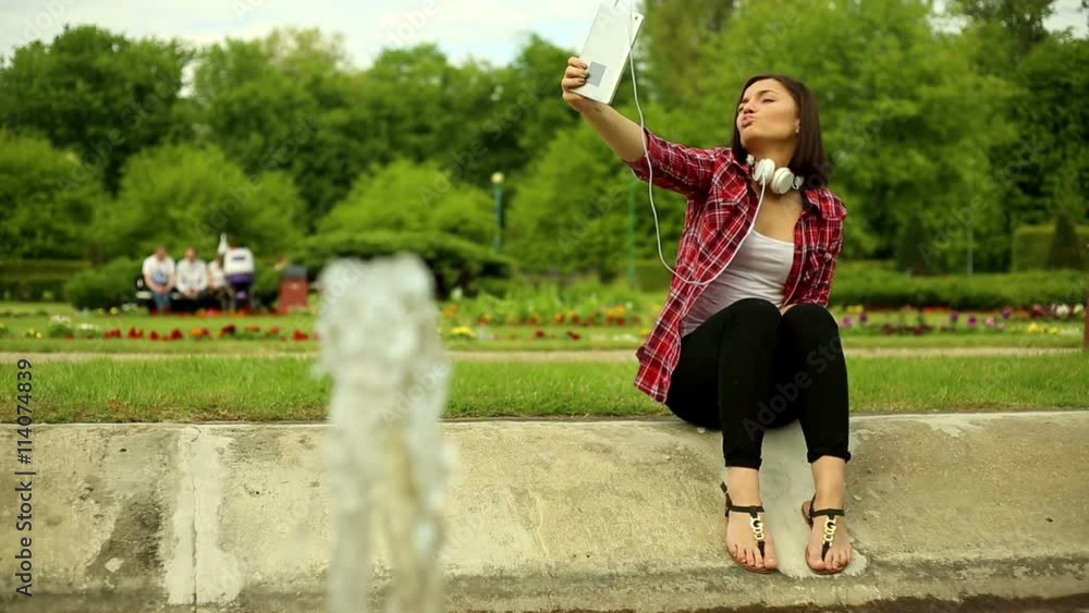 Young woman takes a picture of a tablet
Young woman takes a picture of a tablet