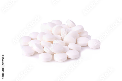 White pills on the white background