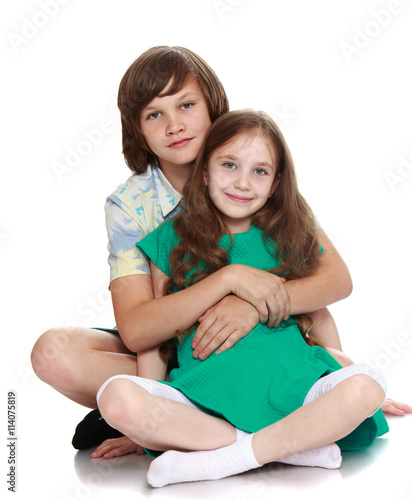 Brother and sister posing for the camera-Isolated on white background