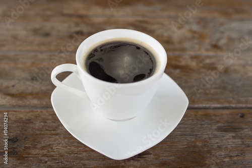 A cup of hot coffee on table.