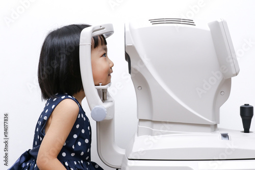 Asian Little Chinese Girl Doing Eyes Examination Through Auto re