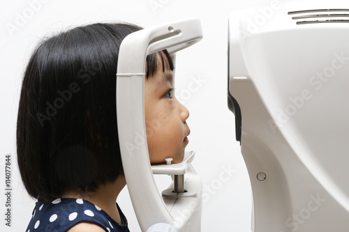 Asian Little Chinese Girl Doing Eyes Examination Through Auto re