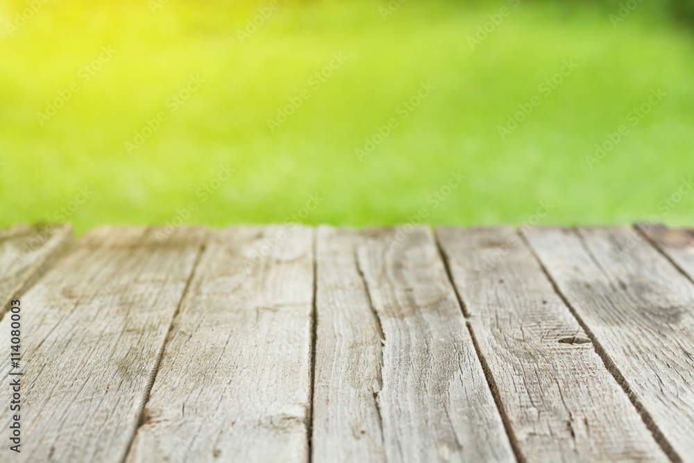 Garden wooden table with green bokeh Garden wooden table with green bokeh