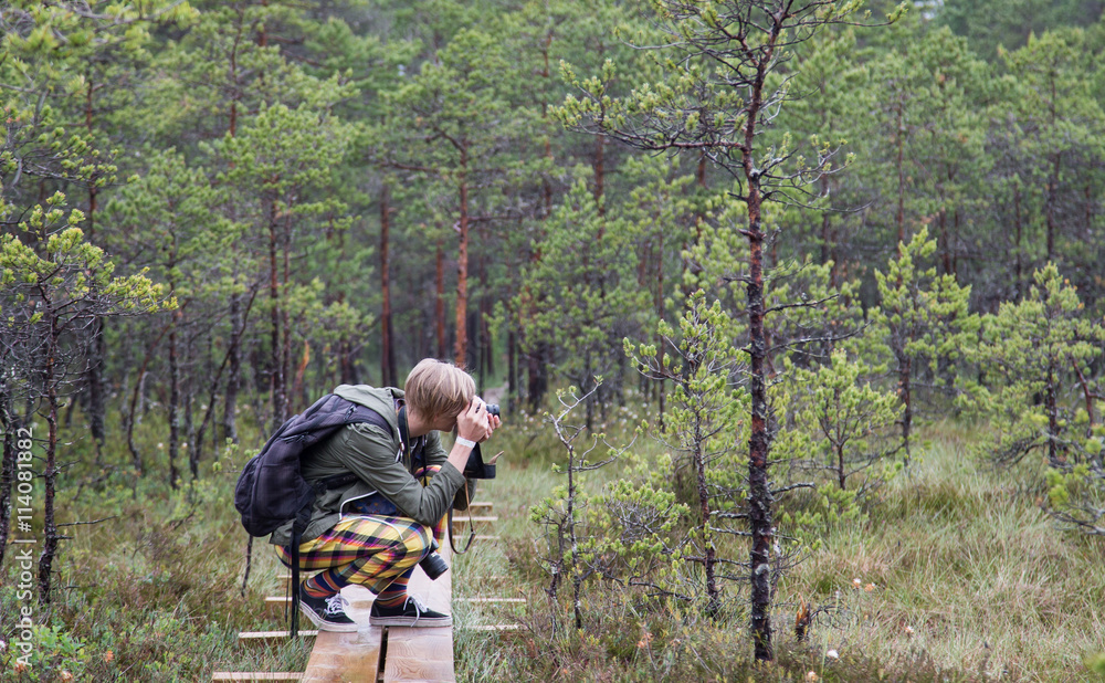 Young man photographing the nature of Kakerdaja Bog in Korvemaa, Estonia Young man photographing the nature of Kakerdaja Bog in Korvemaa, Estonia