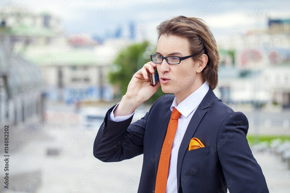 Young successful businessman calling by phone Young successful businessman calling by phone