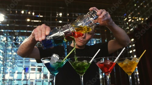 young man working as a bartender in a nightclub bar
