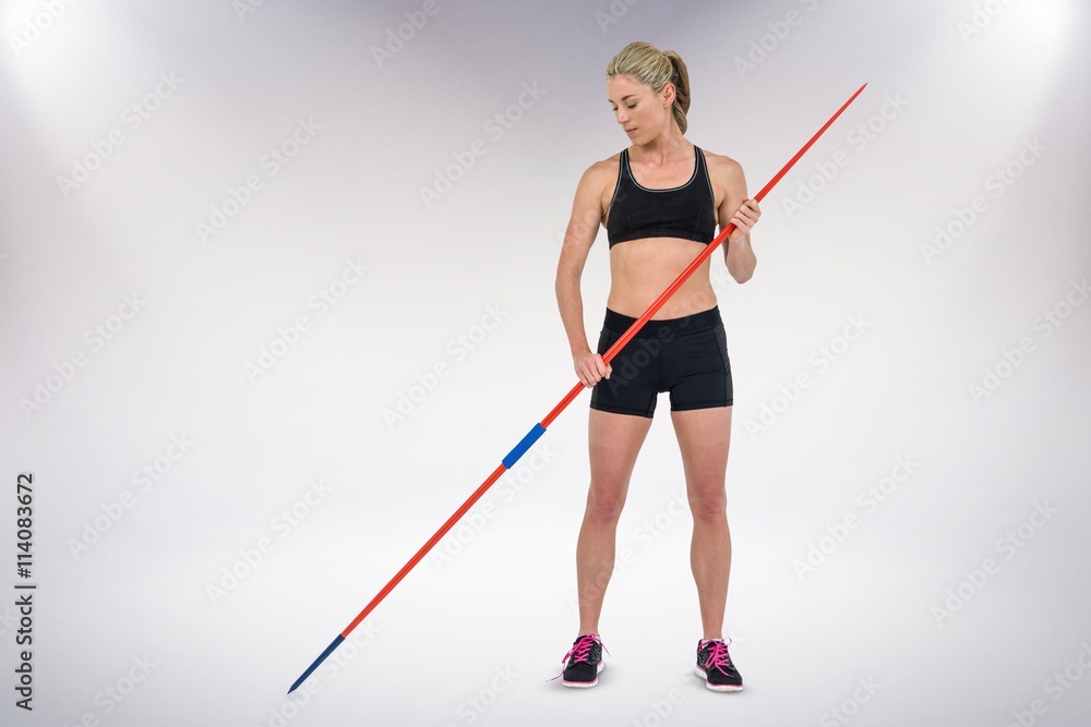 Composite image of athlete standing with javelin Composite image of athlete standing with javelin