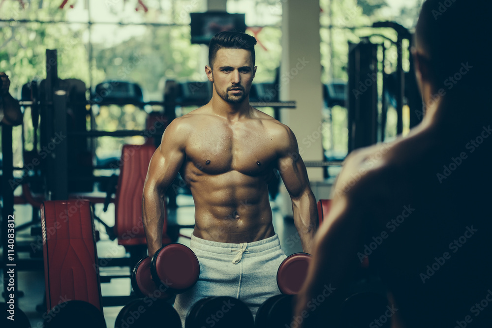 Naklejka premium muscular man with dumbbell