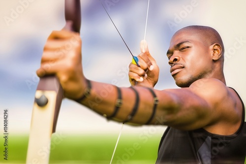 Composite image of front view of sportsman practising archery 