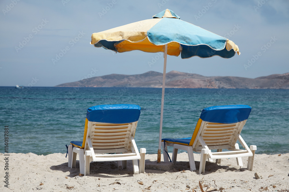 Parasols and sun loungers on the beach island of Kos Parasols and sun loungers on the beach island of Kos