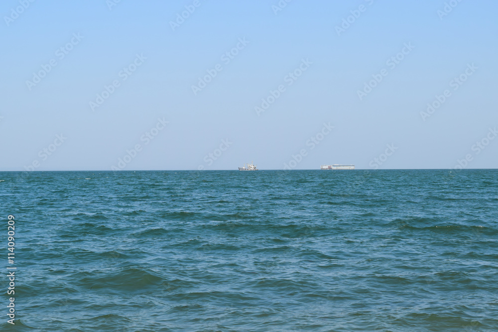Seascape and two ships on the horizon