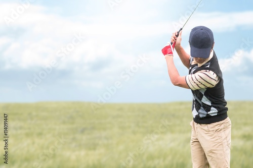 Man playing golf against nature scene