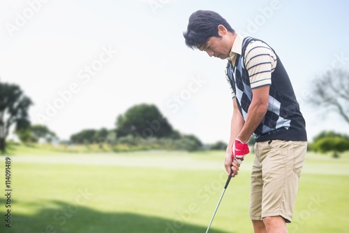 Man playing golf against view of a park
