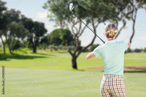 Rear view of woman playing golf 