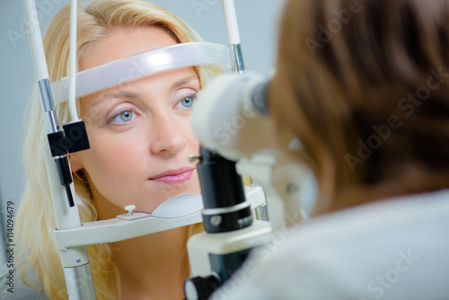 Lady having eye examination photo