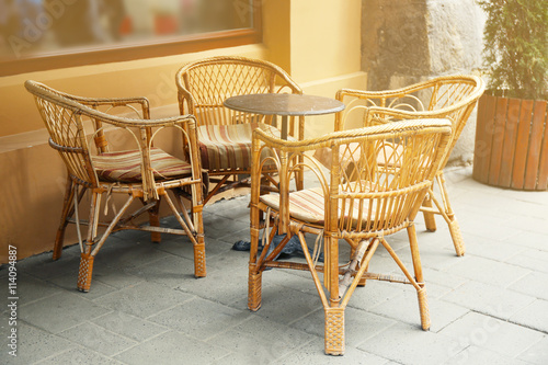 Outdoor cafe table with chairs on a sunny  day