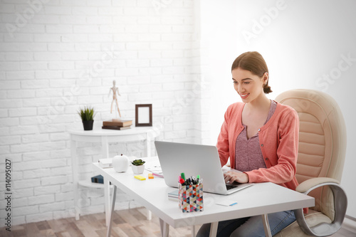 Woman working at computer a...