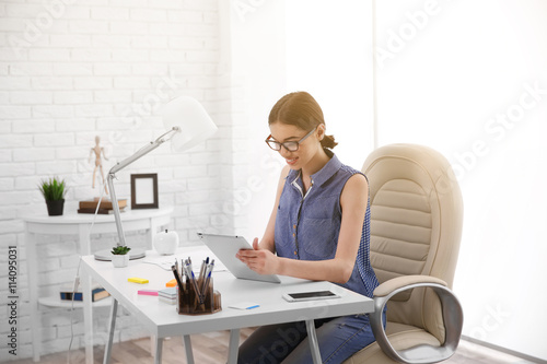 Woman working on tablet at ...