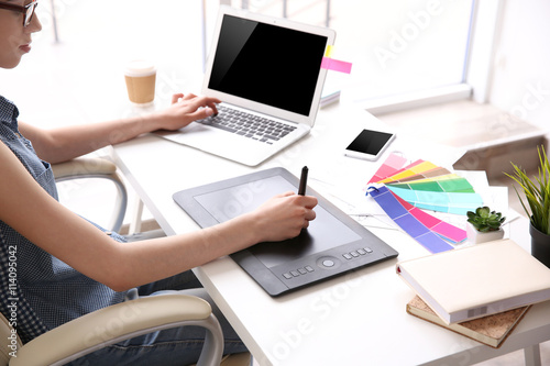 Woman using graphic tablet ...