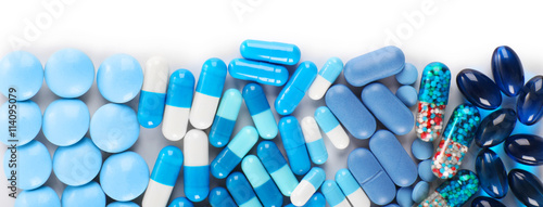 Blue pills isolated on white photo