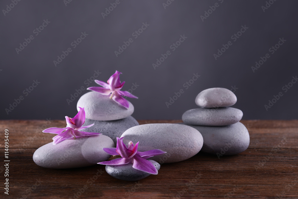 Spa stones and flowers on grey background Spa stones and flowers on grey background