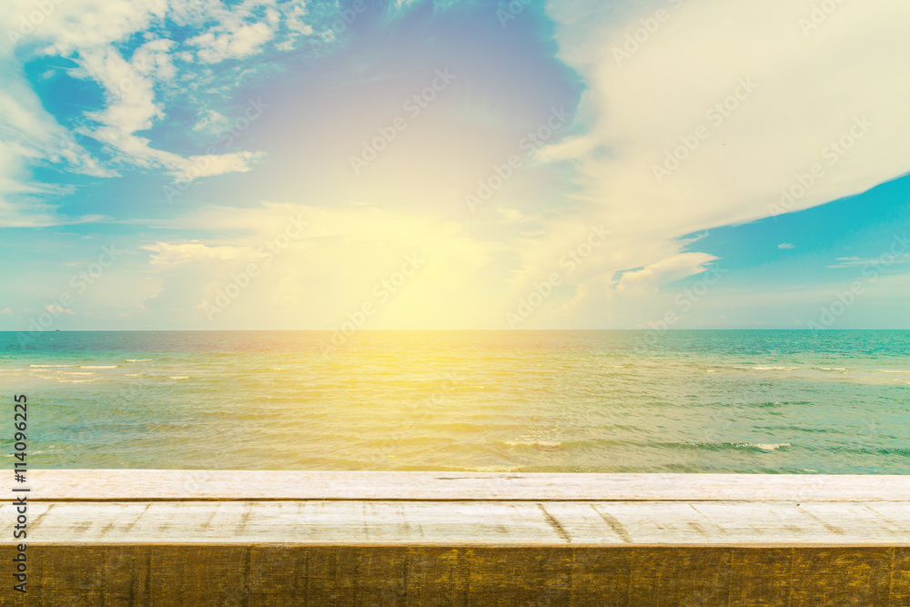 Wood table top on sunrise sky and beach background