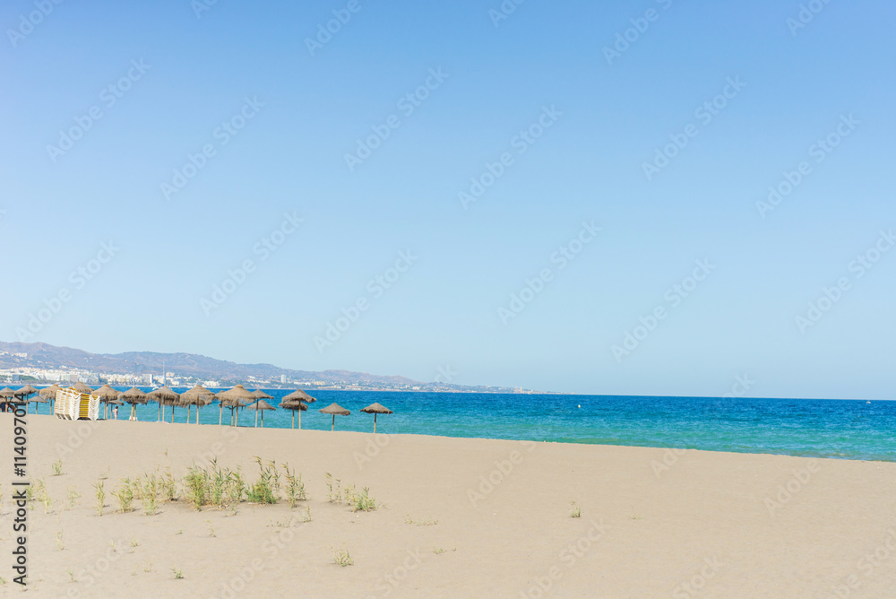 Beautiful mediterranean beach with hammocks and sun umbrellas