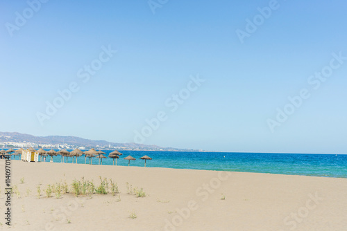 Beautiful mediterranean beach with hammocks and sun umbrellas
