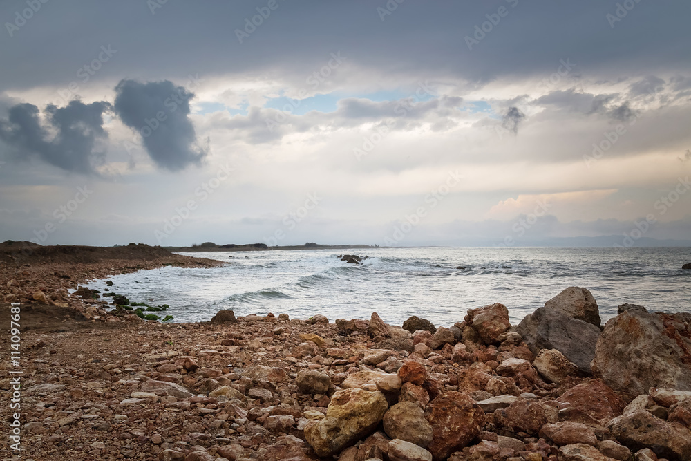 Dark sky, rocky coast and stormy sea Dark sky, rocky coast and stormy sea