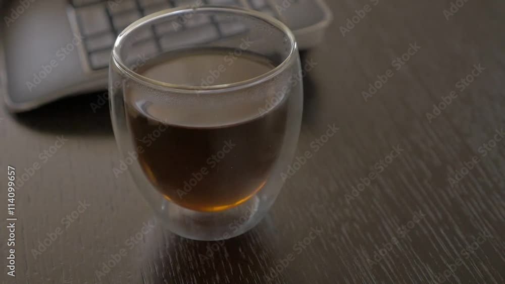 Work place with glass of tea and wireless keyboars 1080p FullHD panning footage - Tea time after finishing job high definition 1920X1080 video Work place with glass of tea and wireless keyboars 1080p FullHD panning footage - Tea time after finishing job high definition 1920X1080 video