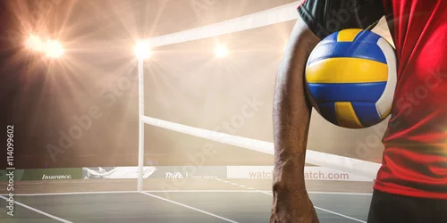 Obraz Złożony obraz środkowej części sportowca trzymającego siatkówkę