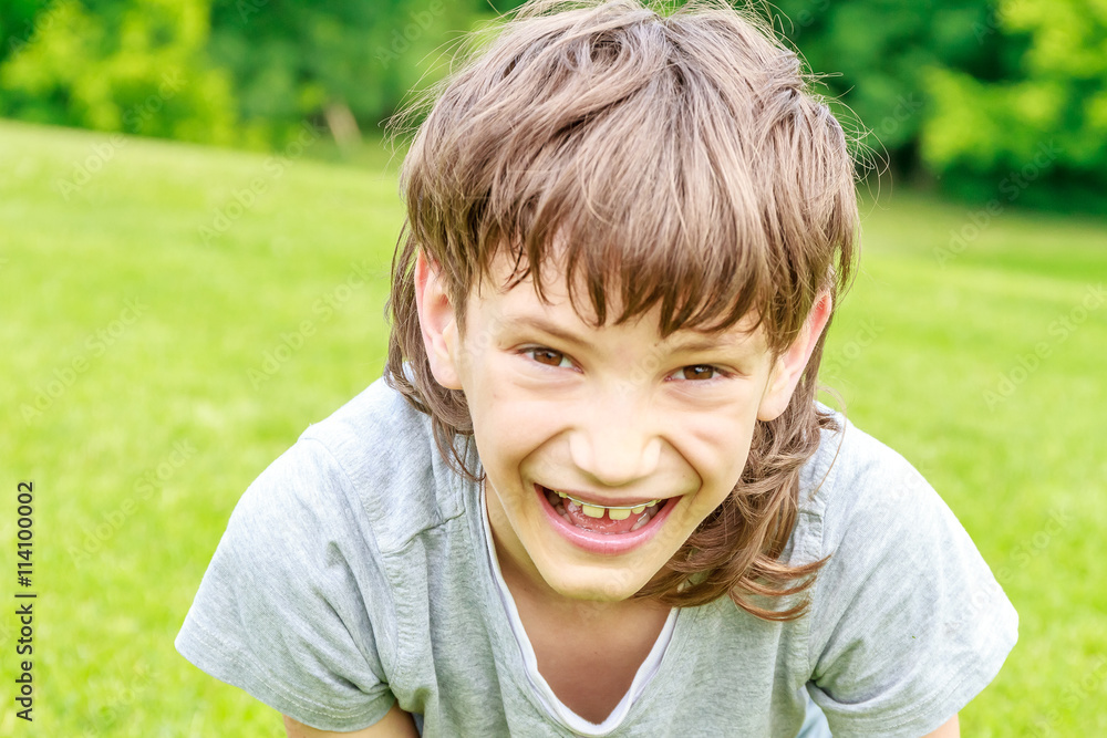 Adorable young child boy in the park. On warm summer day during Adorable young child boy in the park. On warm summer day during