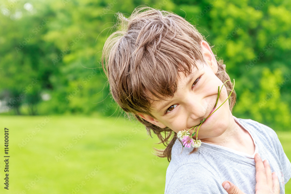 Adorable young child boy in the park. On warm summer day during Adorable young child boy in the park. On warm summer day during