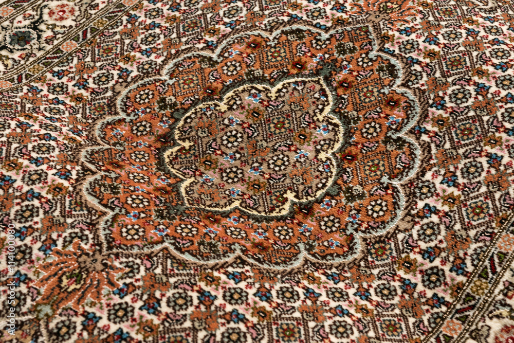 Close up of the central medallion of a fine persian Tabriz Mahi Close up of the central medallion of a fine persian Tabriz Mahi