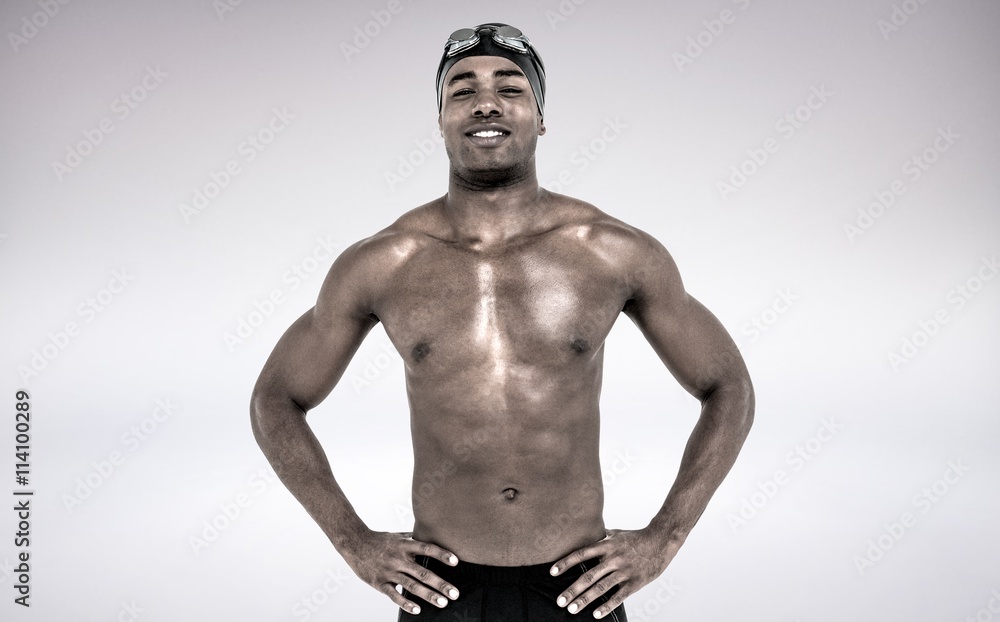 Fototapeta premium Composite image of swimmer smiling and posing