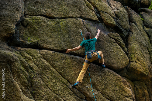 Fototapeta Naklejka Na Ścianę i Meble -  Men climbing vertical wall, Poland