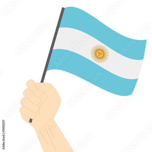 Hand holding and raising the national flag of Argentina