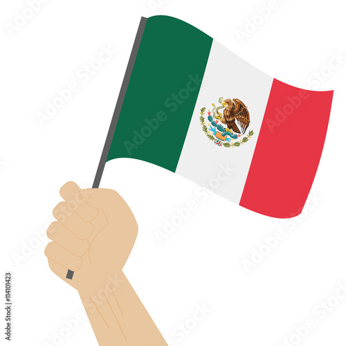 Hand holding and raising the national flag of Mexico